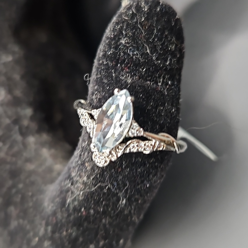 A-4 Silverstone ring with light blue stone and clear accents